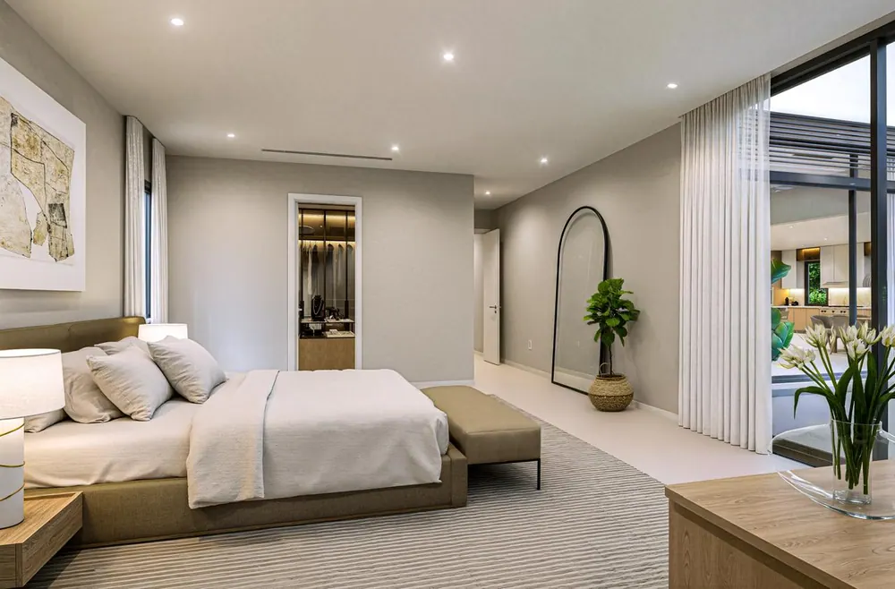 Primary bedroom suite with walk-in closet and courtyard glass